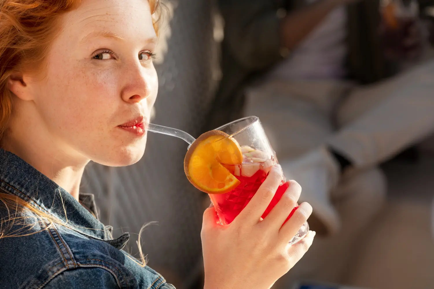 Woman enjoying Heaven Soda from a glass – gut-friendly, low-sugar, probiotic drink with bold flavour.